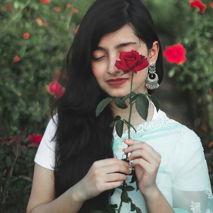 Alexa Chen, Lead Design Curator at Longterm Project Group, reviewing corporate floral arrangements